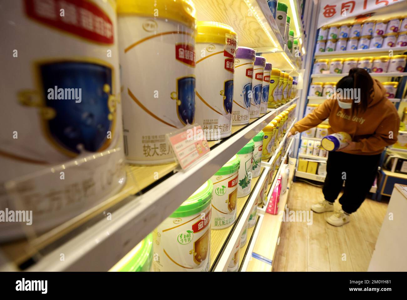 People buy baby milk powder at a supermarket in Zaozhuang, East China's ...