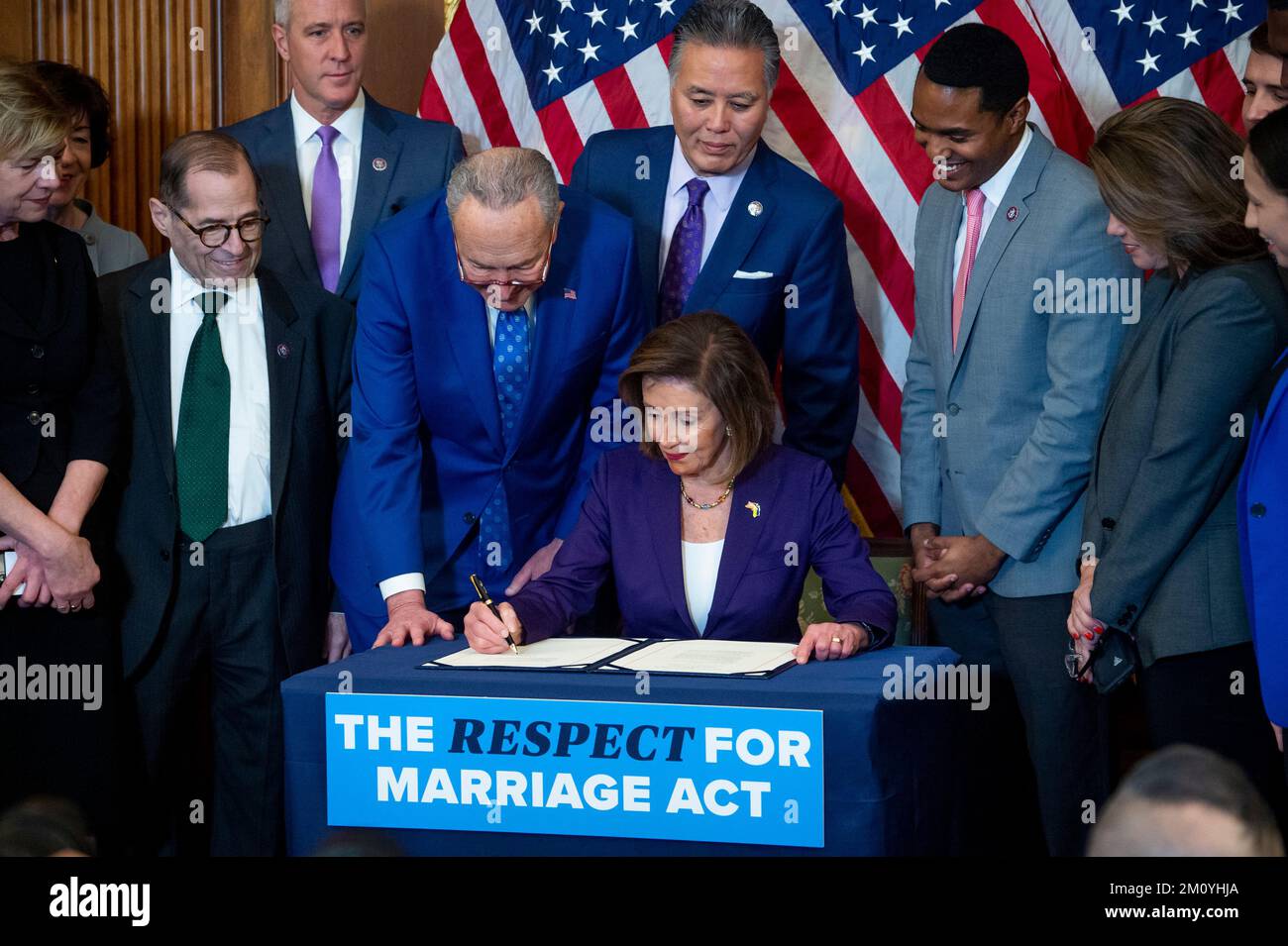 Speaker of the United States House of Representatives Nancy Pelosi (Democrat of California) is joined by United States Senate Majority Leader Chuck Schumer (Democrat of New York) and bipartisan Senate and House members as she signs H.R.8404, the “Respect for Marriage Act” during a bill enrollment ceremony at the US Capitol in Washington, DC, Thursday, December 8, 2022. Credit: Rod Lamkey/CNP /MediaPunch Stock Photo