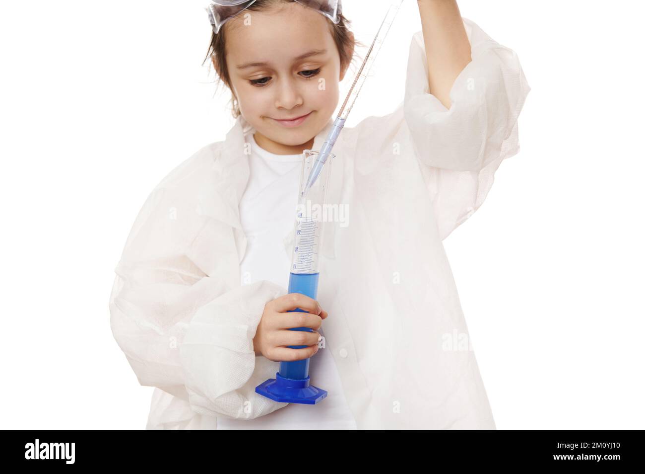 Closeup little girl fills the glass laboratory graduated pipette with