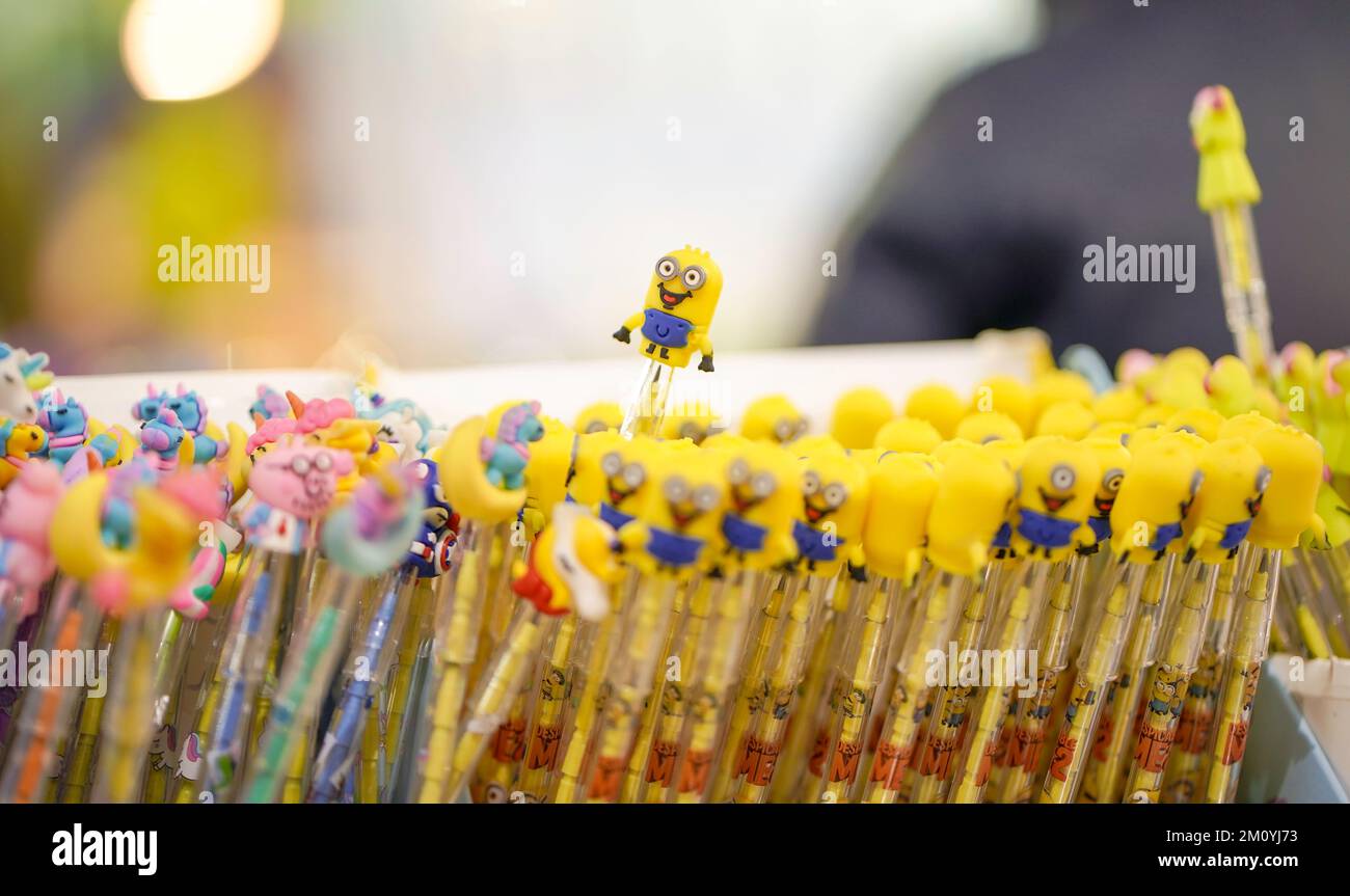 Monday, November 28, 2022, Raipur, india. A minion toy on the upper side of a pencil kept in sets and selling in market, mall, store, stationary Stock Photo