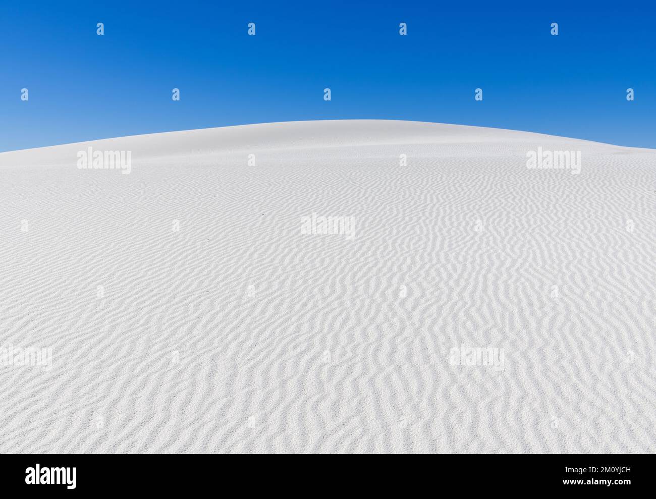 Peaceful scene of rounded white sand dune with abstract patterns in White Sands National Park, New Mexico Stock Photo