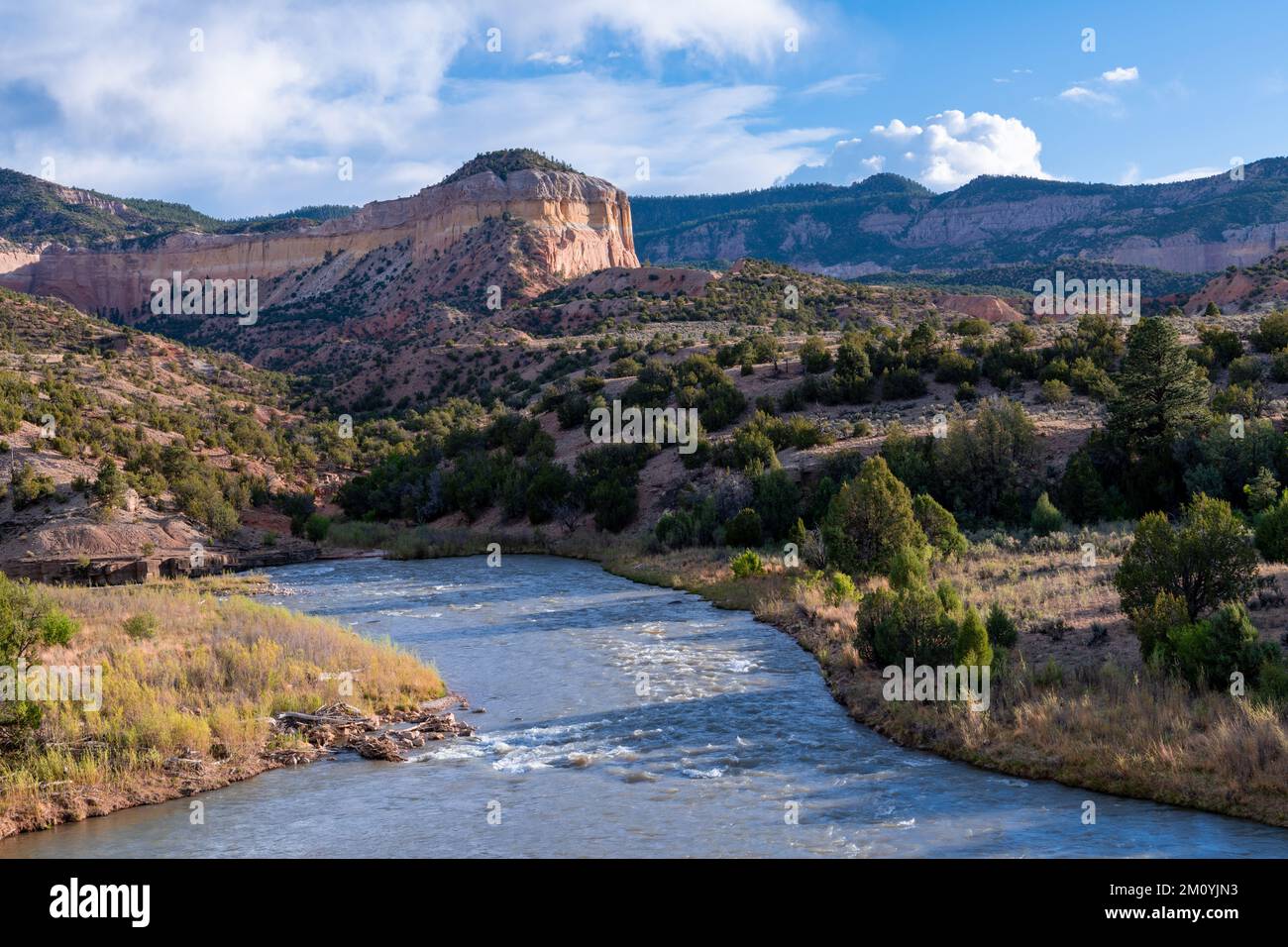 Rio Chama river flows through a colorful desert landscape of mesas and mountains in New Mexico