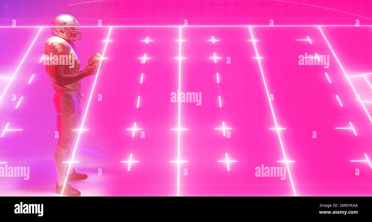 Composite of illuminated american football ground and player with ball