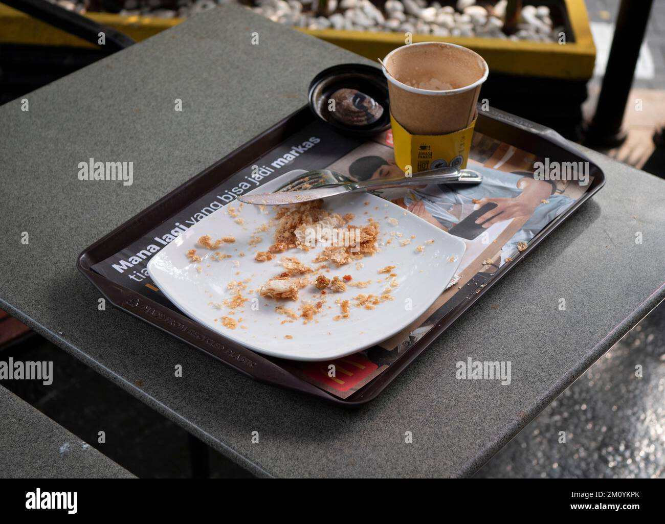 Jakarta, Indonesia-Nov 24, 2022: Trays, plates and glasses of leftover food on the table Stock Photo