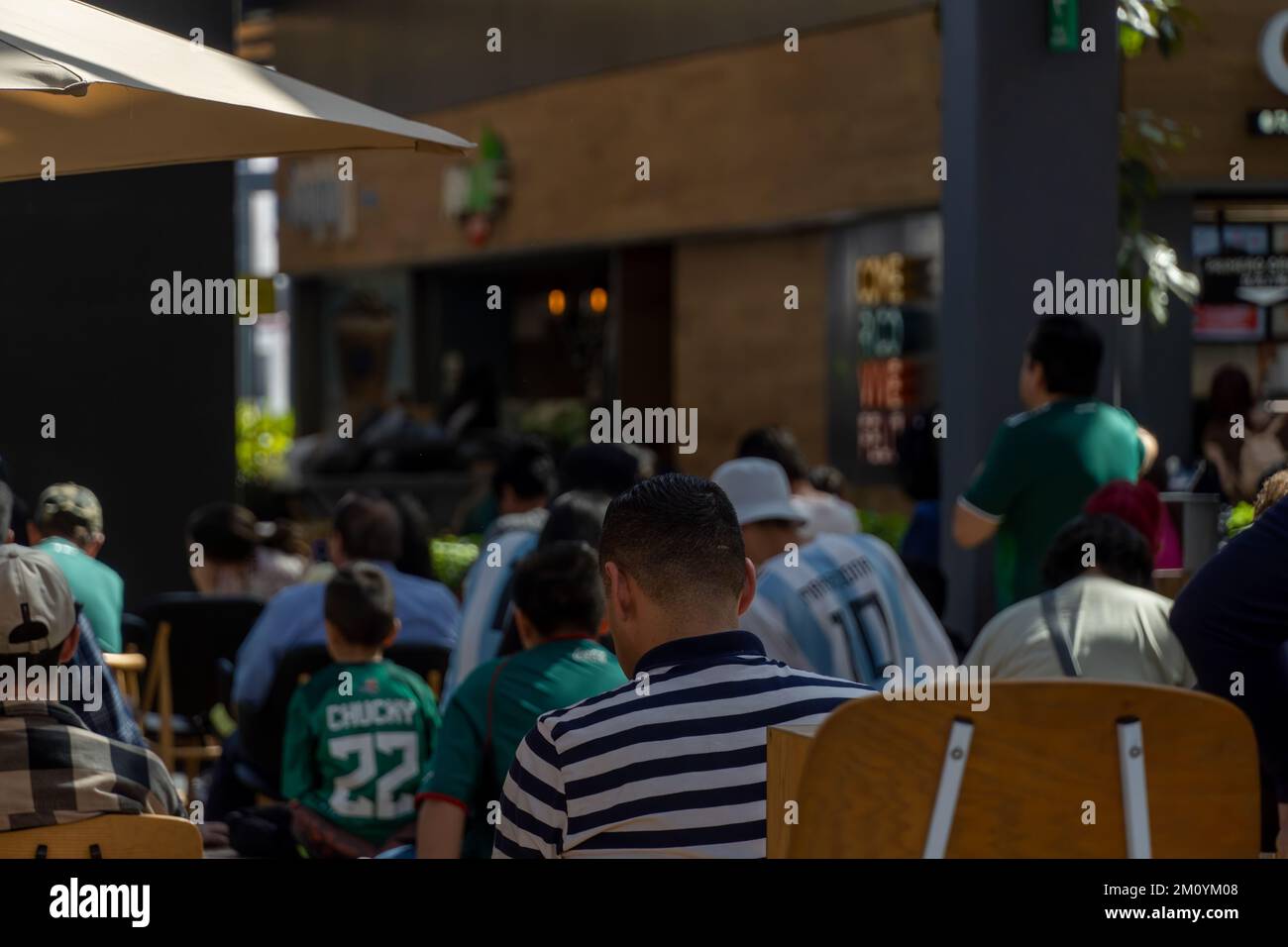 Fans of Mexico during the World Cup Round watching the game in a shopping mall Stock Photo