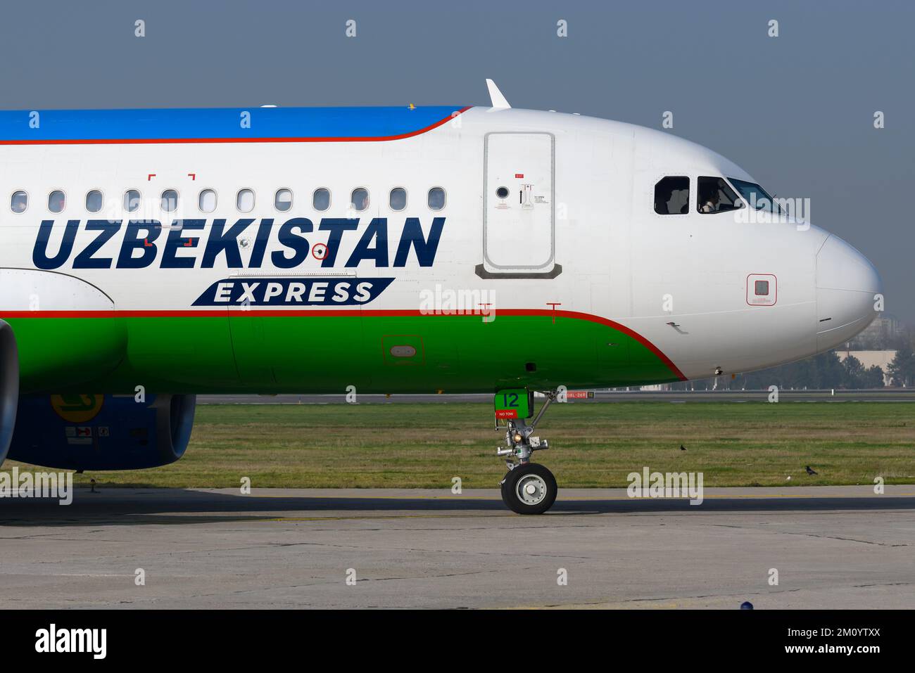 Uzbekistan Airways Express Airbus A320 aircraft taxiing at Tashkent Airport in Uzbekistan. Airplane of Uzbekistan Express. Plane registered as UK32012 Stock Photo