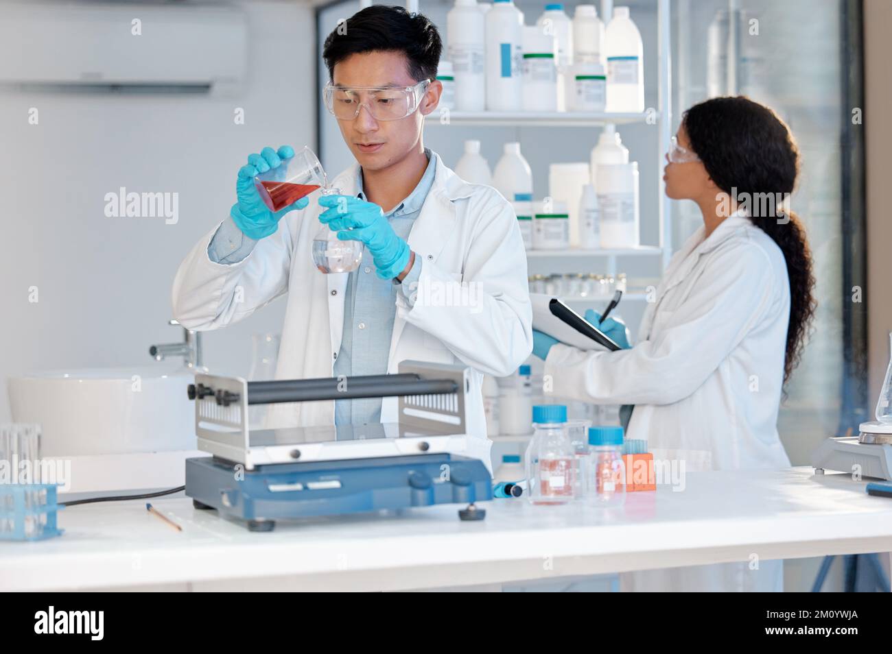 This is where the hard work happens. a young male lab tech filling samples in the lab. Stock Photo