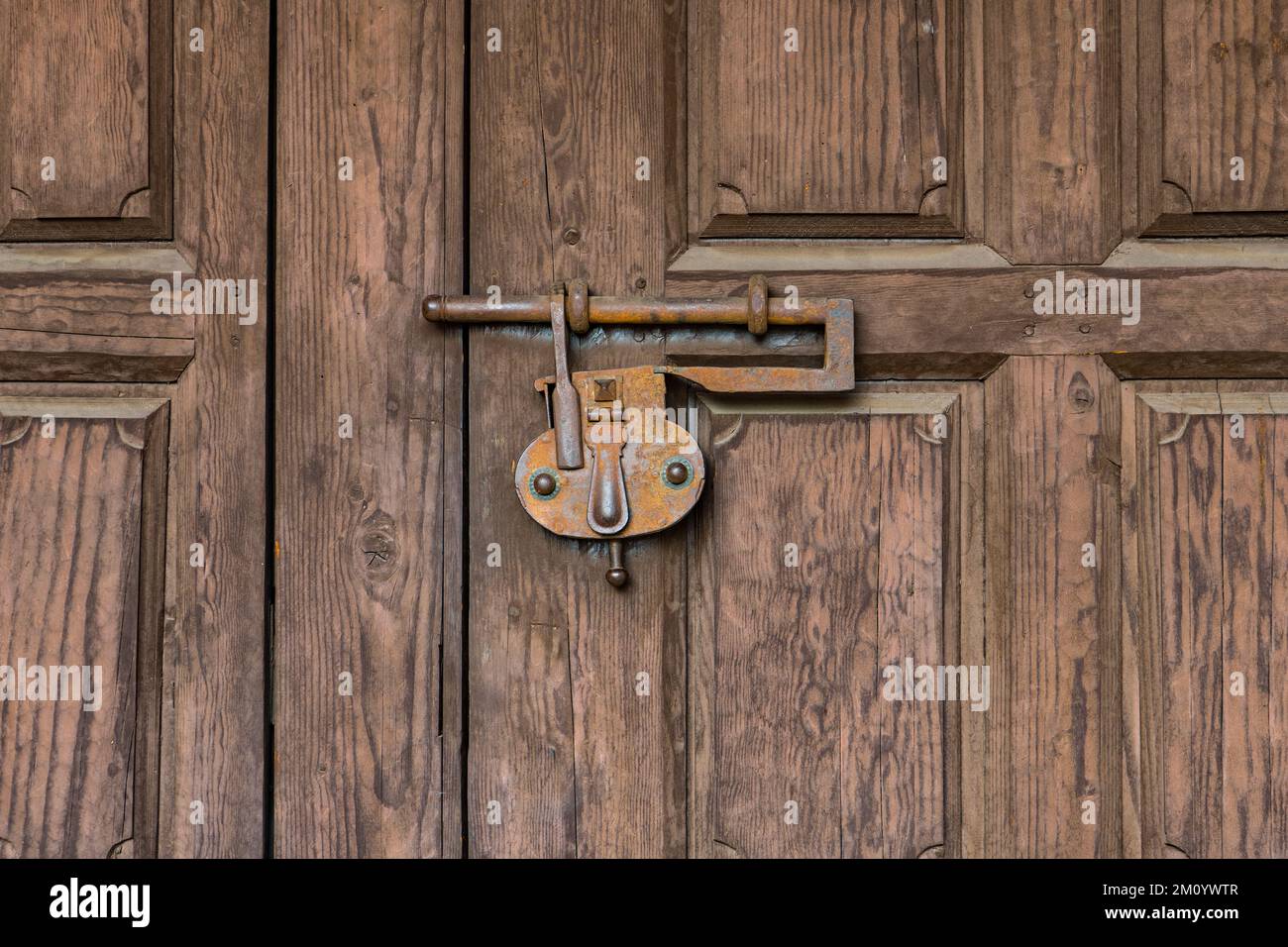Vintage rusted lock latching a rustic wood door shut Stock Photo Alamy