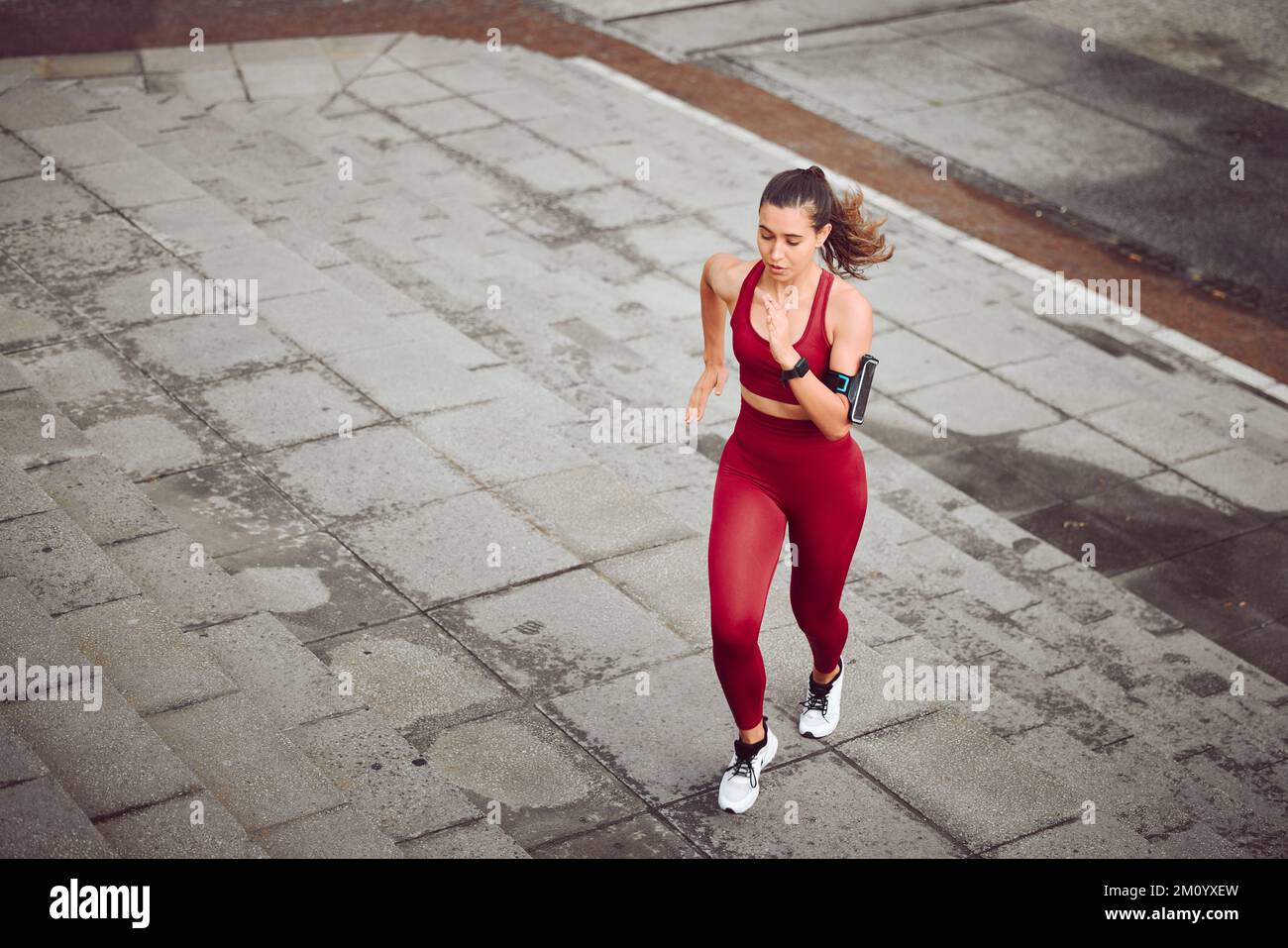 Going hard. High angle shot of an attractive young female athlete running outdoors. Stock Photo