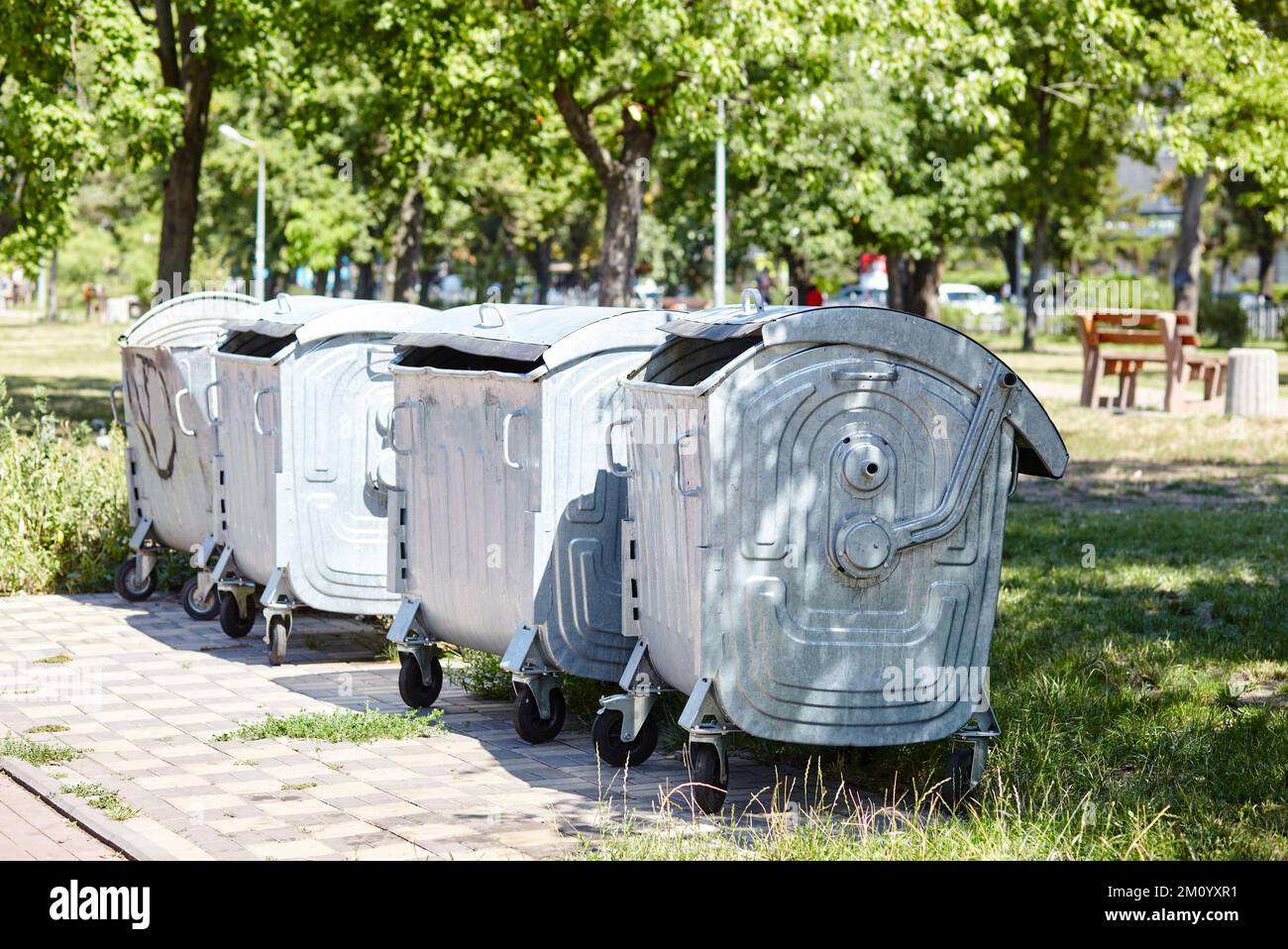 Garbage cans in the city park. Garbage container in a public park. Environment, city life, sanitary standards Stock Photo