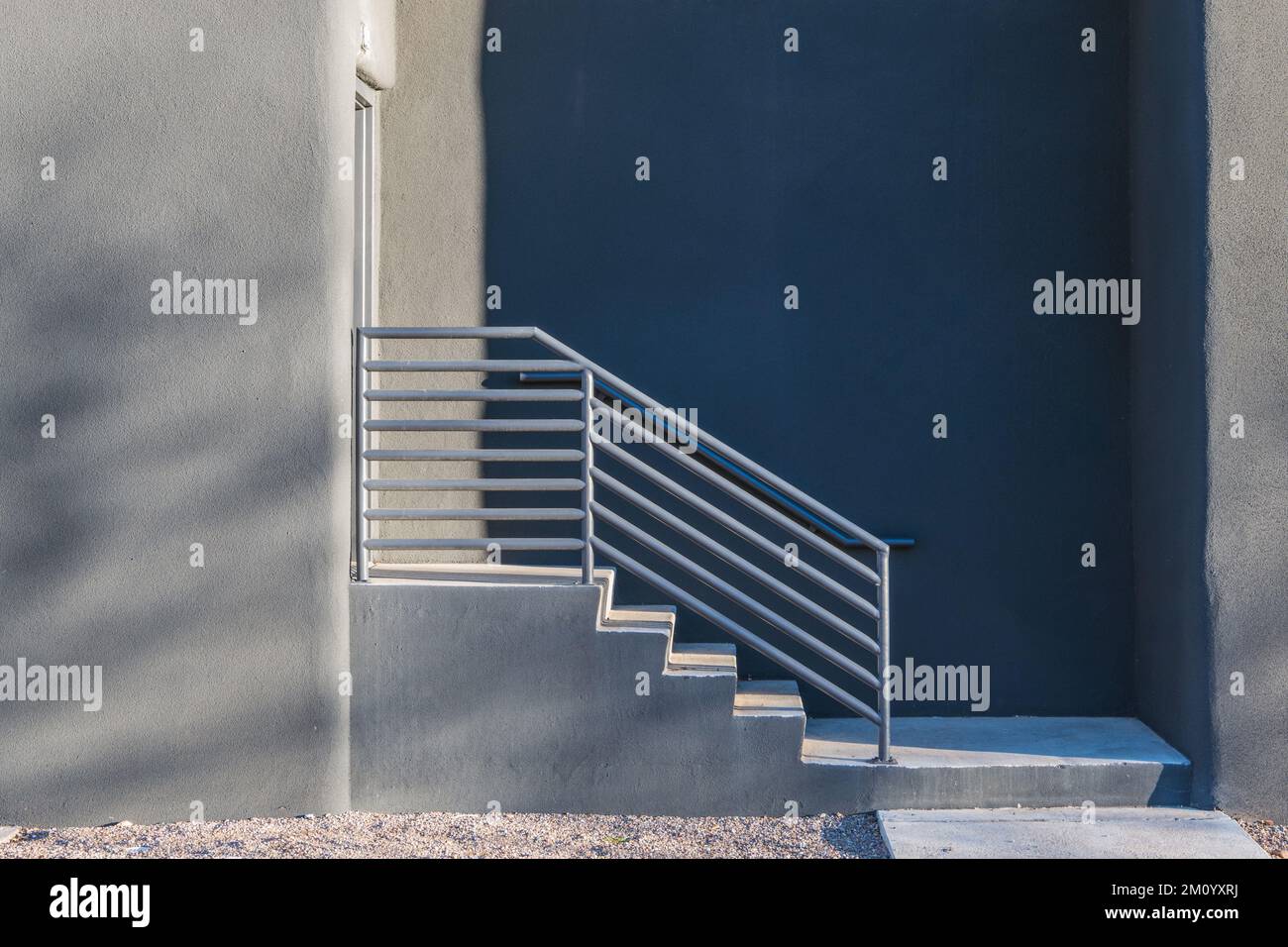 Side view of concrete steps and railing leading to an entrance in a ...