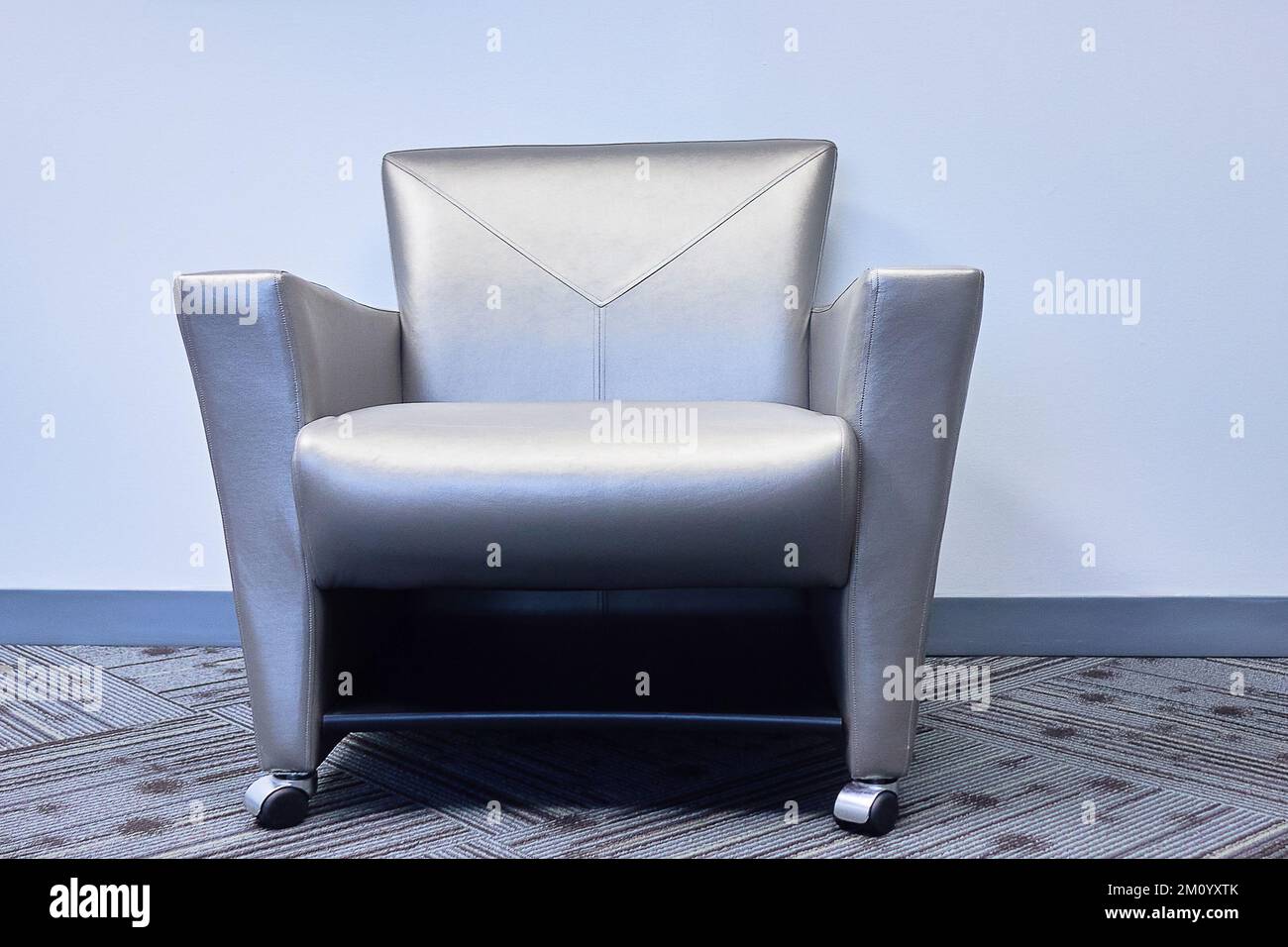 grey office chair carpet grey wall leather chair Stock Photo