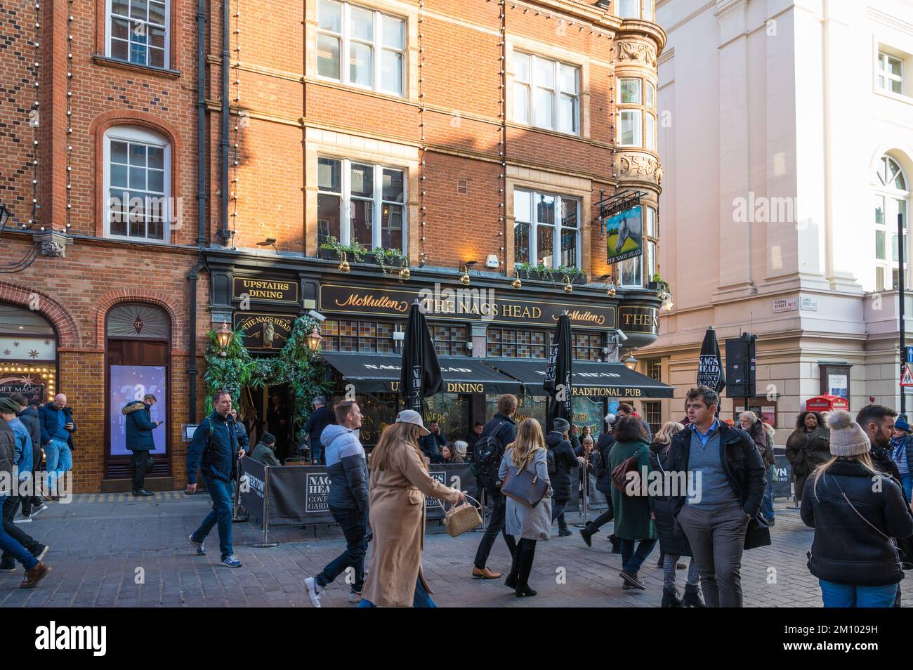 Covent Garden. People shopping pass by the Nags Head pub on James Street. London, England, UK Stock Photo