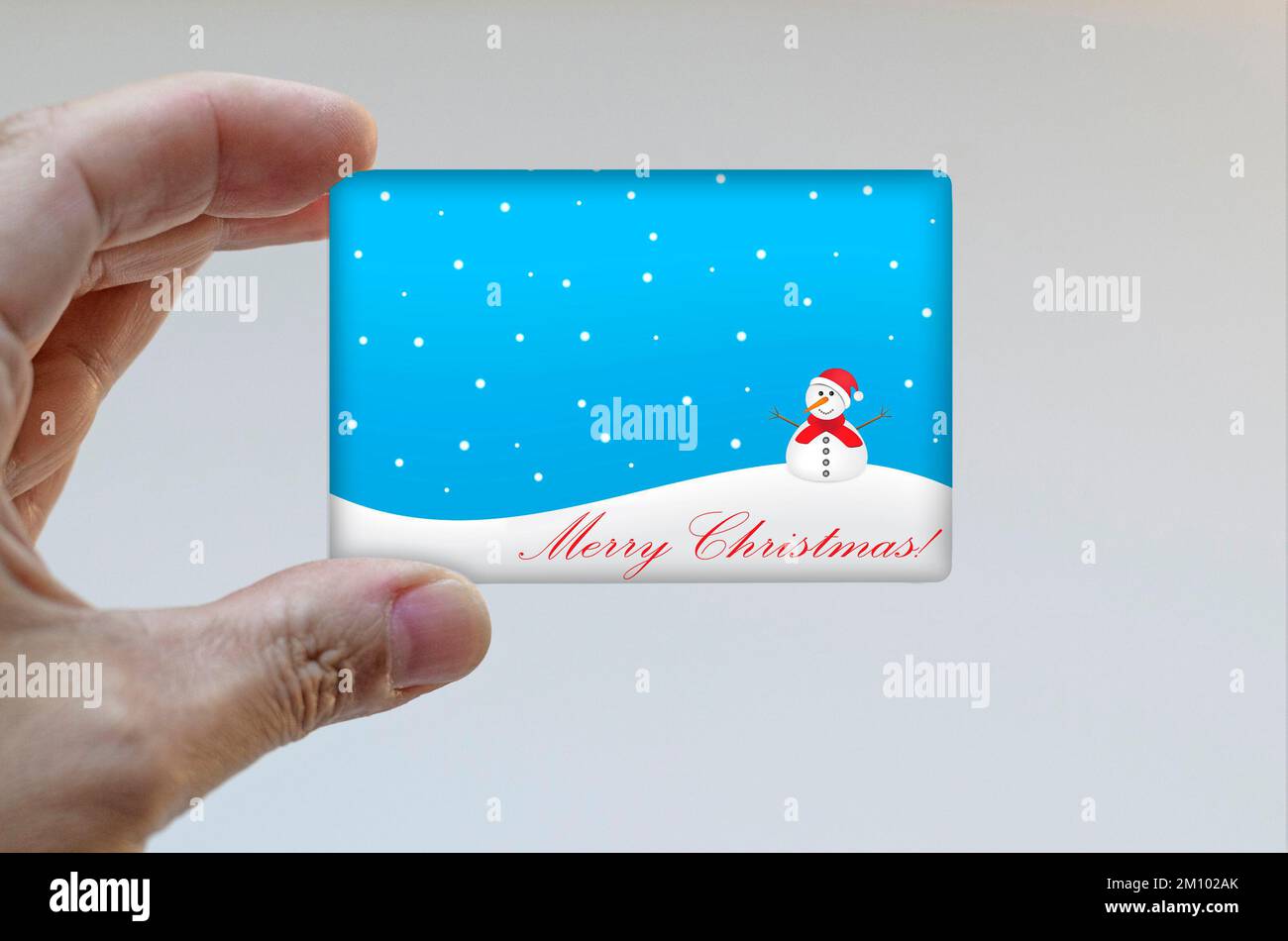 Hand holding a Christmas card Stock Photo - Alamy