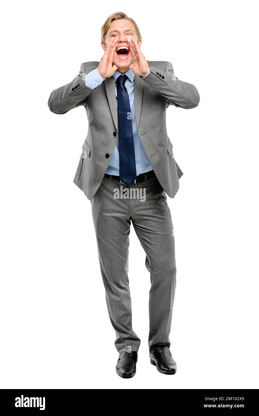 Listen up. Full length shot of a handsome young businessman standing alone in the studio and yelling. Stock Photo