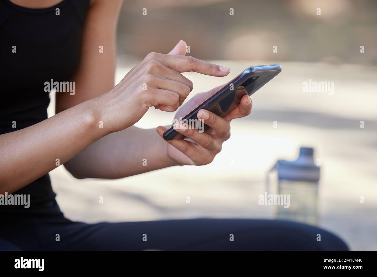 Smartphone, fitness and woman hands with outdoor mobile app, social media post and website blog tips for wellness, nutrition and training. Athlete Stock Photo