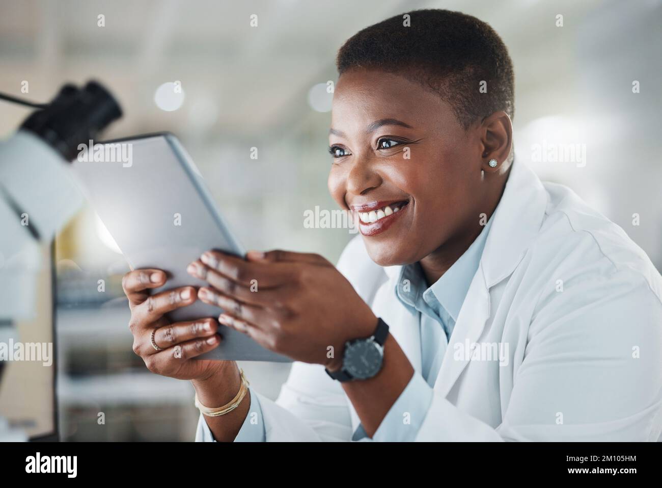 My work directly impacts the world. a young scientist using a digital tablet while working in a lab. Stock Photo