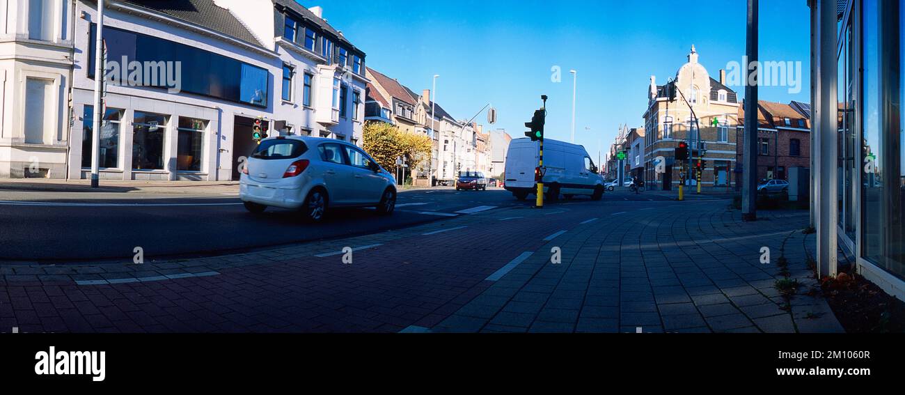 panoramic lowangle view on traffic passing a signalized junction on a sunny day Stock Photo