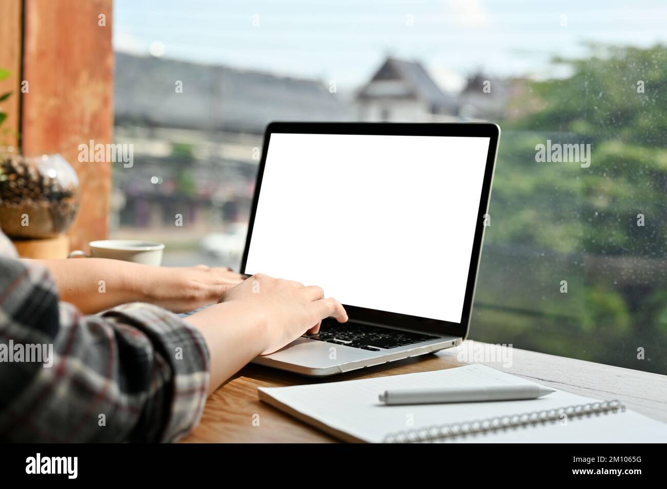 Side view, close-up image, A female freelancer using laptop computer ...