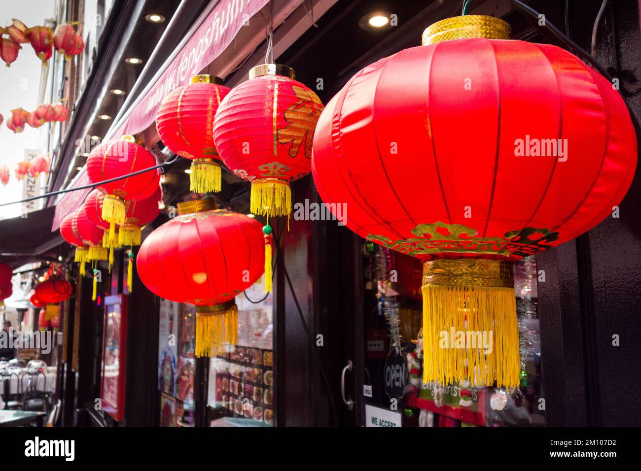 Bright red Chinese lanterns outside a restaurant in Chinatown, in Soho in London's West End, England, UK. Stock Photo