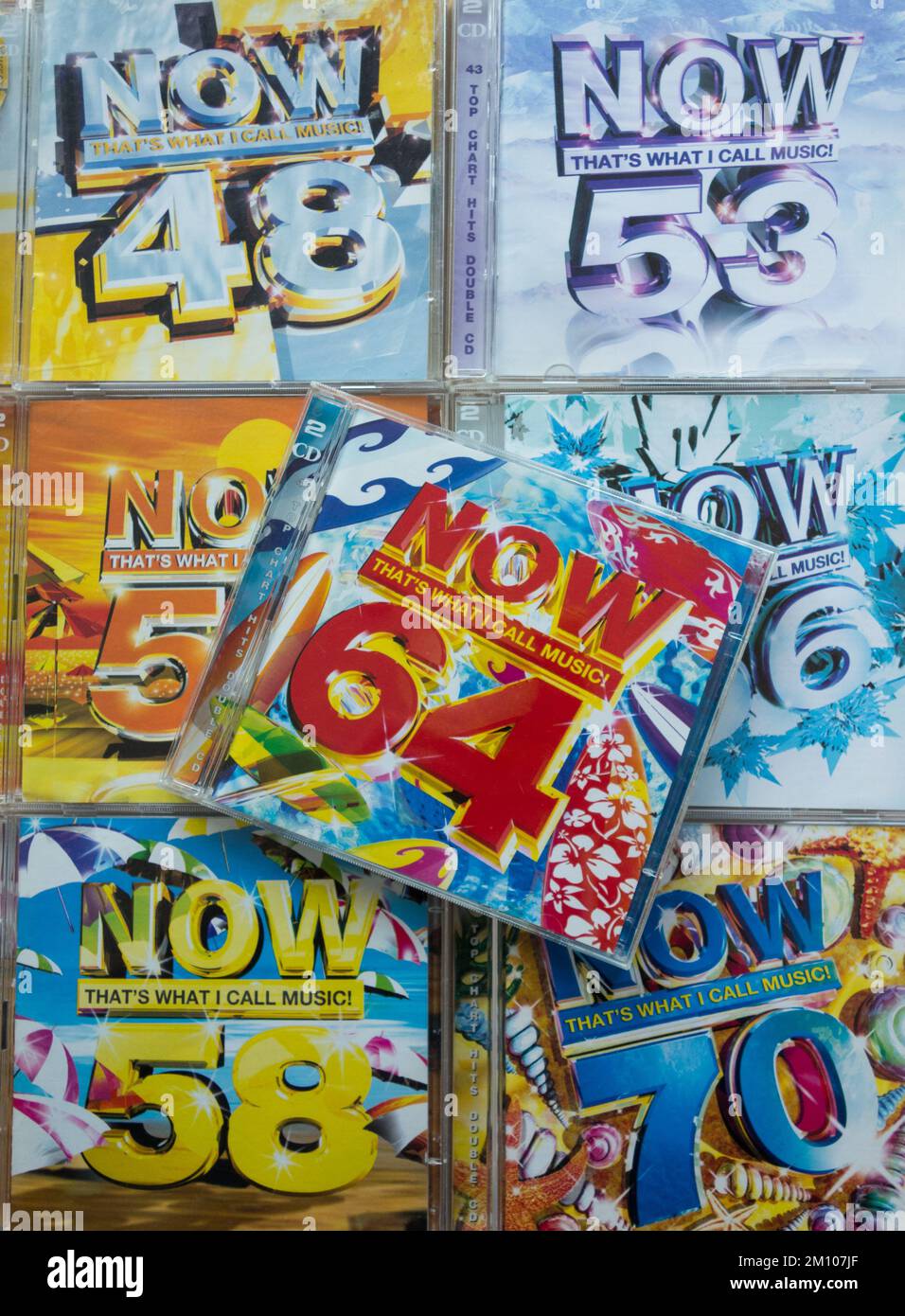Closeup of colourful NOW That's What I call Music CD Covers Stock Photo
