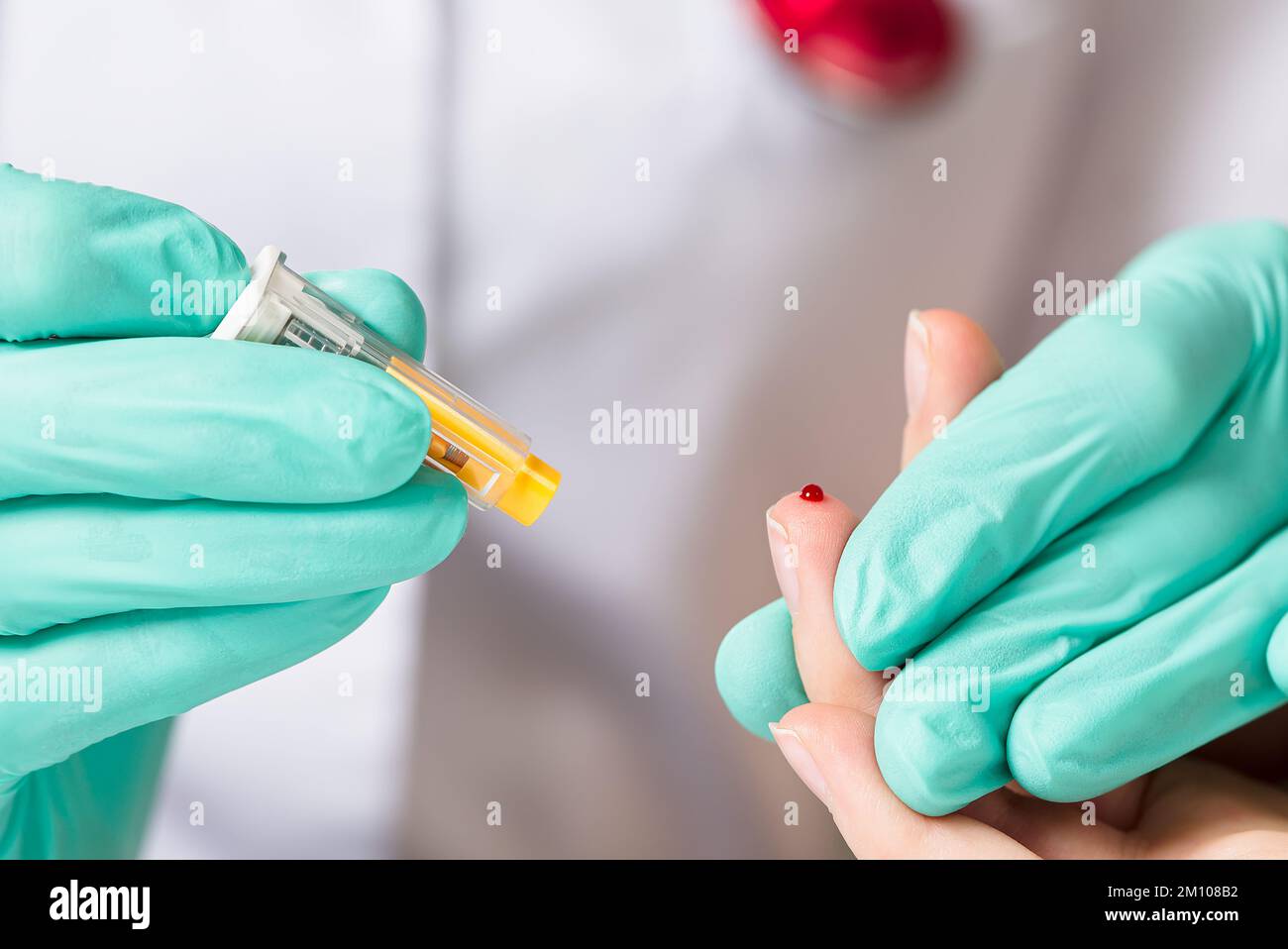 Doctor piercing patients finger with lancet in clinic closeup. Taking