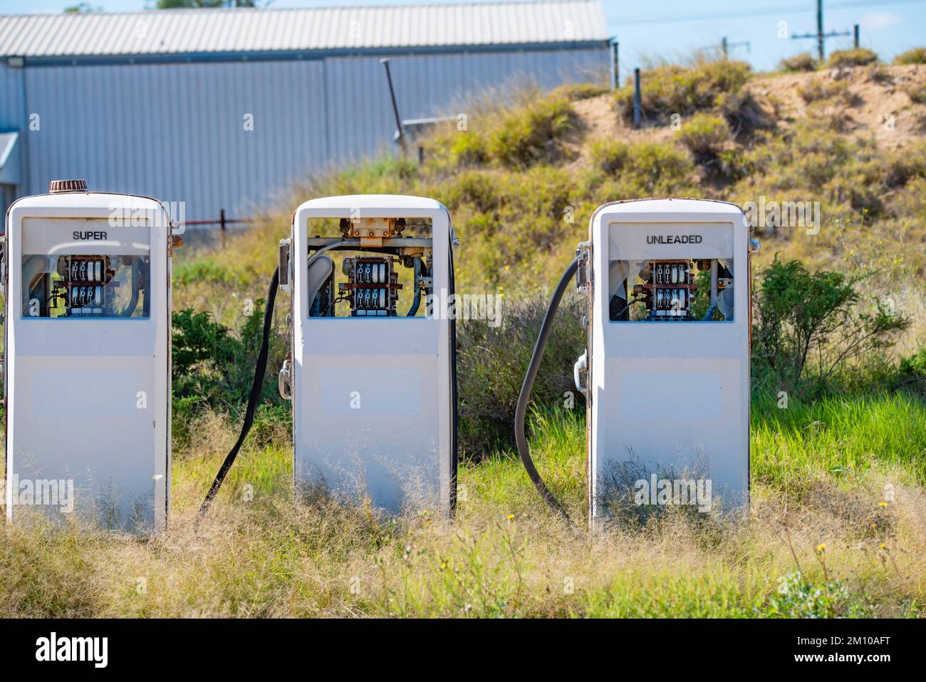 Three abandoned and disused fuel bowsers or gas pumps at the village of Goodooga in outback New South Wales, Australia Stock Photo