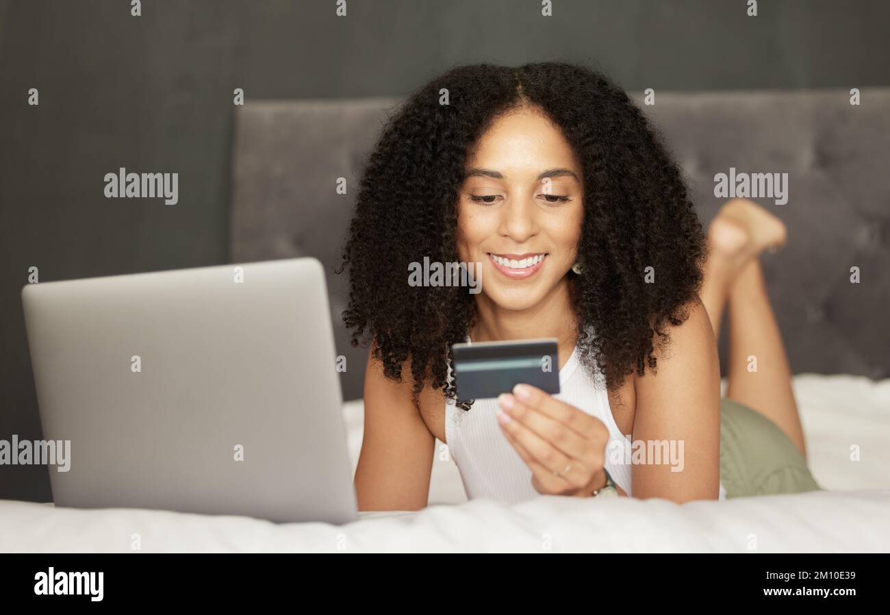 Credit card, online shopping or black woman on bed with laptop for bill