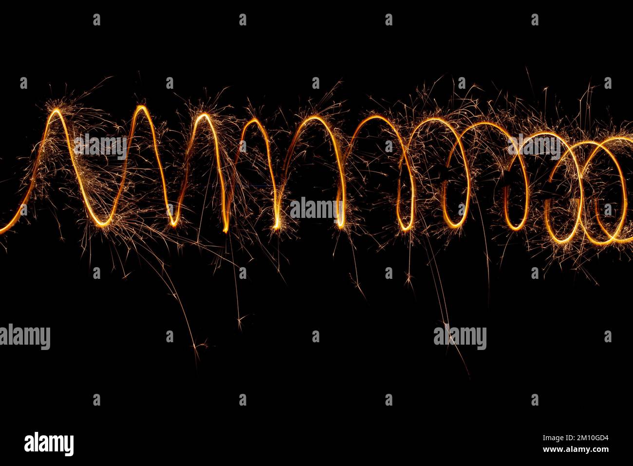 Spiral lights with sparks on a black background. Christmas lights on a