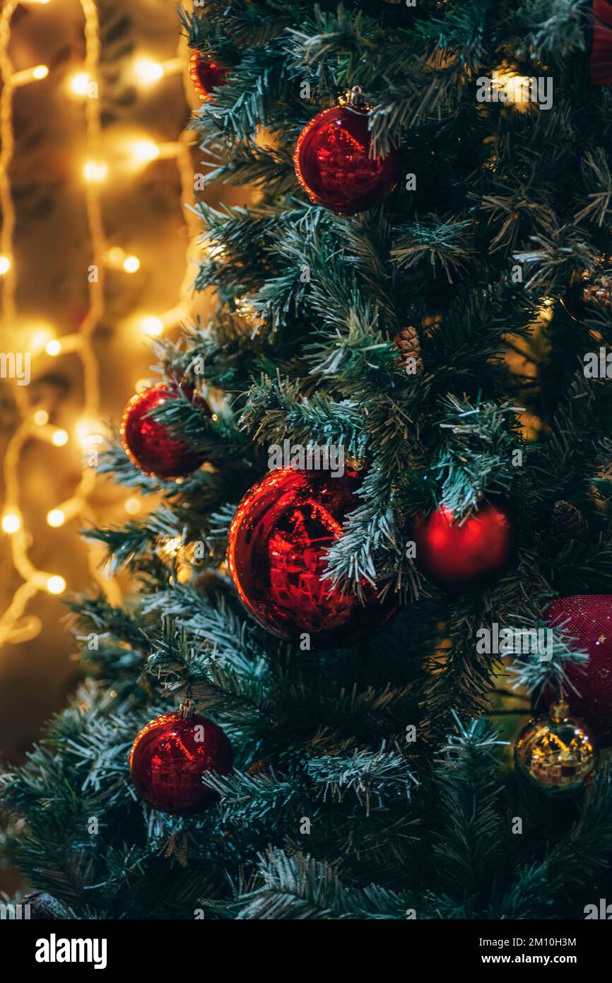 Amazing Christmas decorations on fir tree with red balls and Christmas  lights, blurred background Stock Photo - Alamy