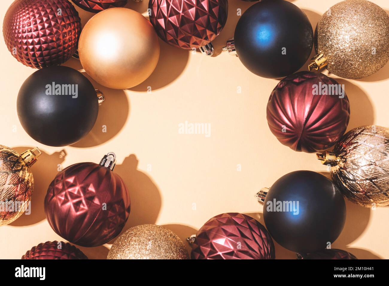 Circle frame of colorful Christmas balls on light beige background with ...