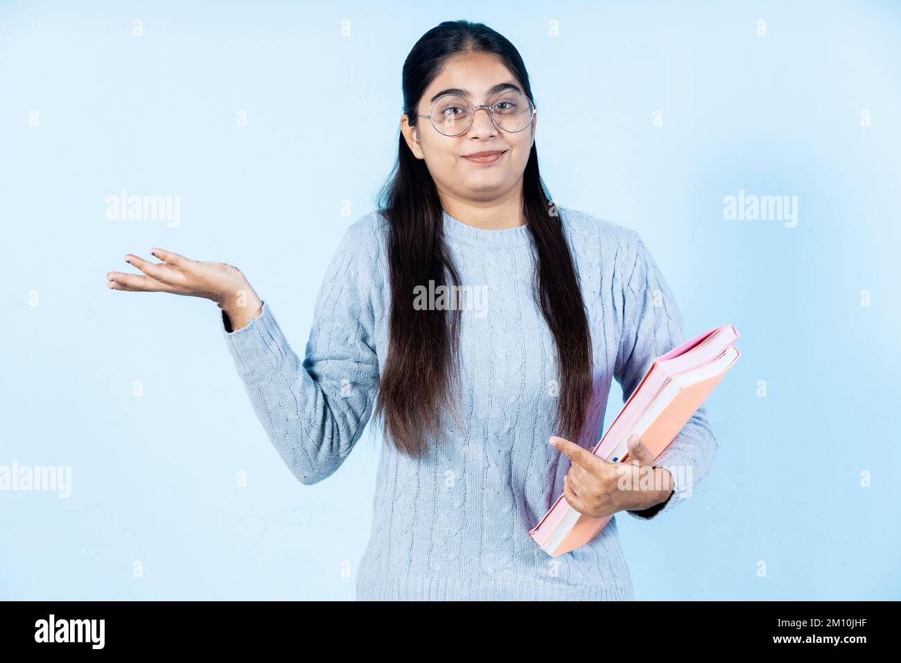 indian young student girl holding book Stock Photo - Alamy