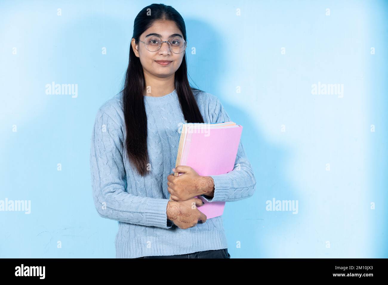 indian young student girl holding book Stock Photo - Alamy