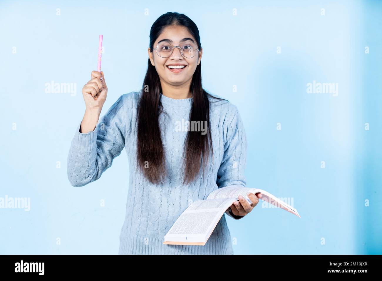 indian young student girl holding book Stock Photo - Alamy