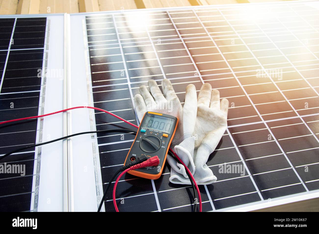 Using Multimeter On Solar Panel Multimeter and glove pictured on solar panel Stock Photo - Alamy