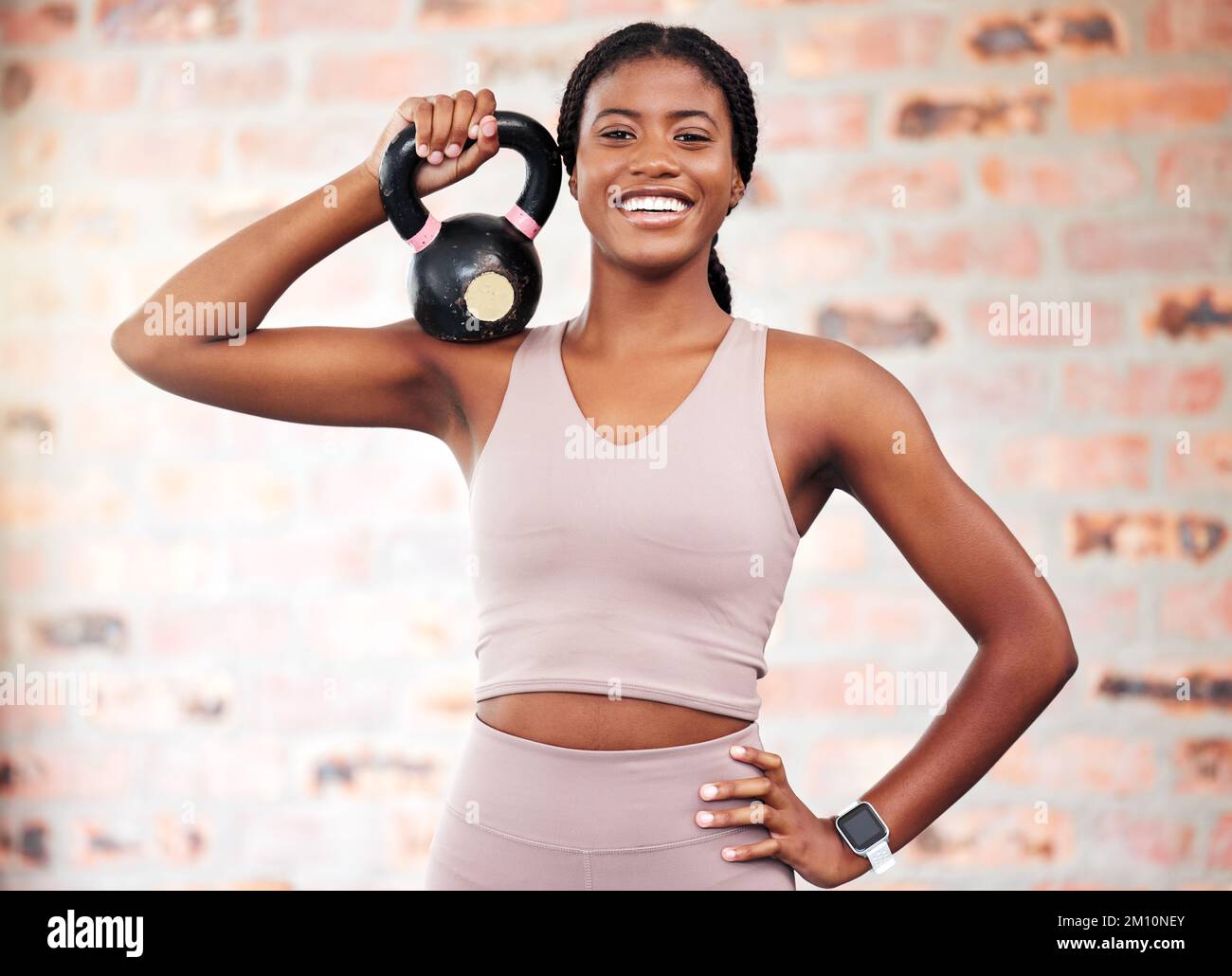 African woman, gym portrait and kettlebell with smile at training, weightlifting and summer body beauty. Black woman bodybuilder, strong or happy Stock Photo