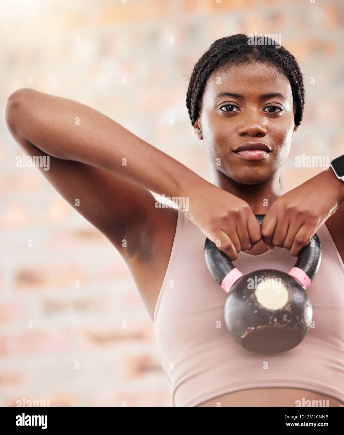 Kettlebell, black woman portrait and fitness in a wellness, training and health gym for sport. Sports workout, exercise and strong arm muscle for Stock Photo