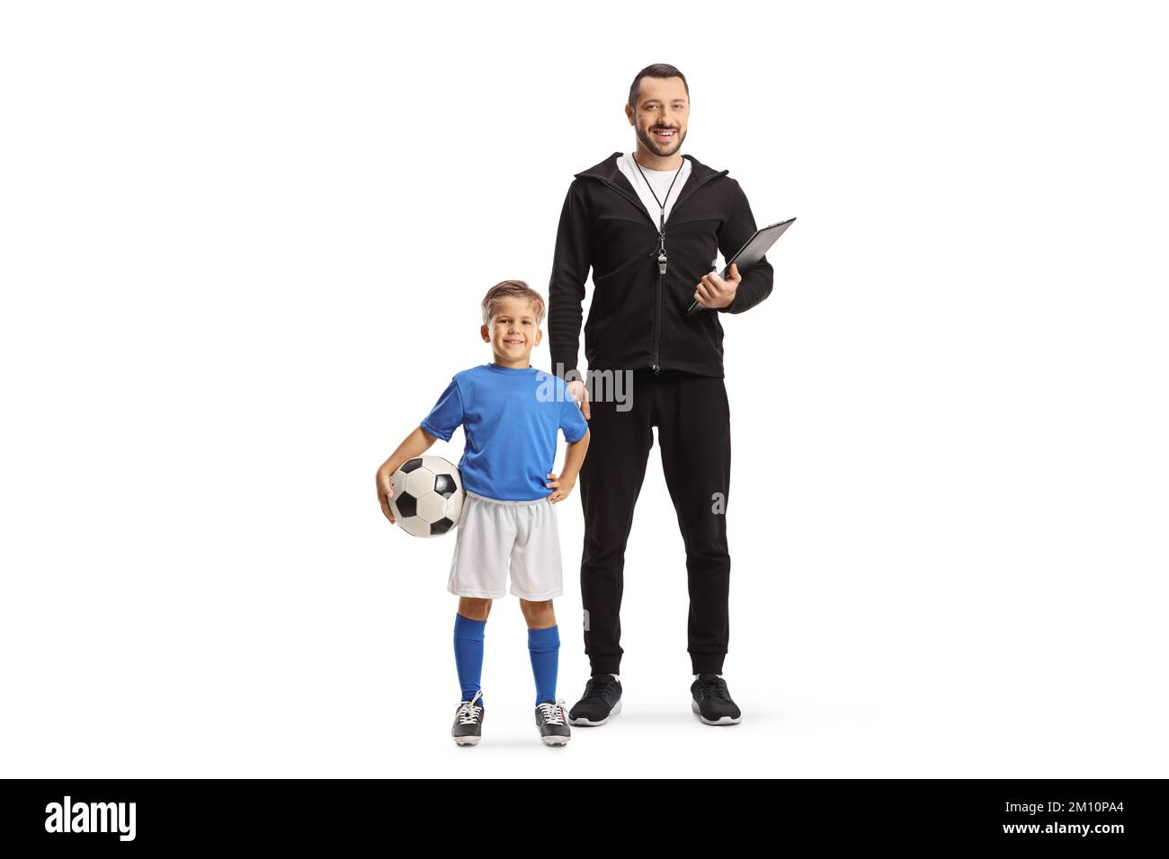 Football coach with a whistle holding a clipboard and a boy standing next to him isolated on white background Stock Photo