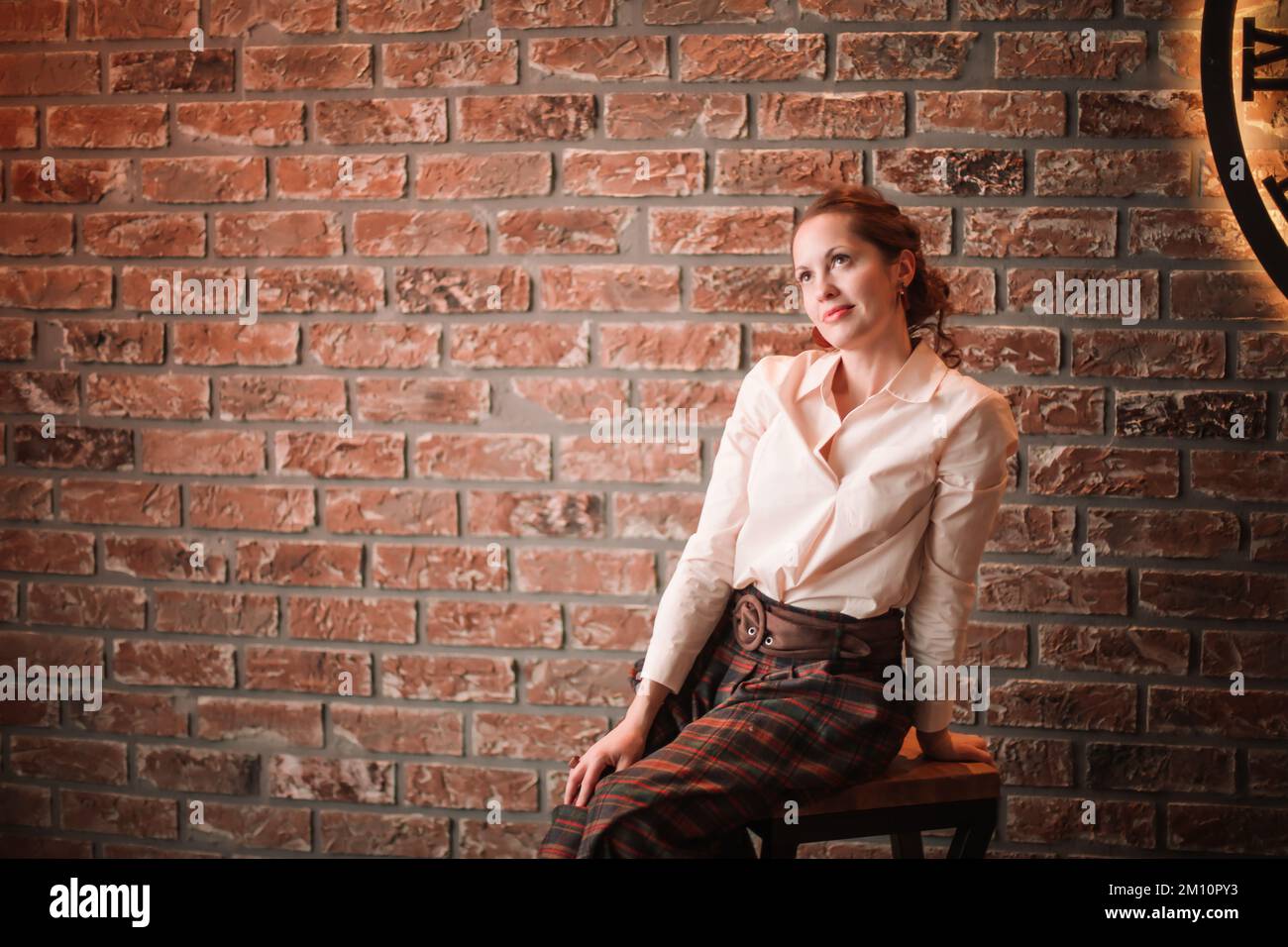 portrait of beautiful young woman on brick wall background Stock Photo ...