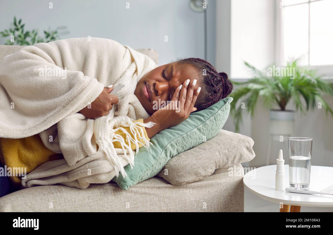 Sick Young African American Woman Is Not Feeling Well And Is Lying At sick-young-african-american-woman-is-not-feeling-well-and-is-lying-at