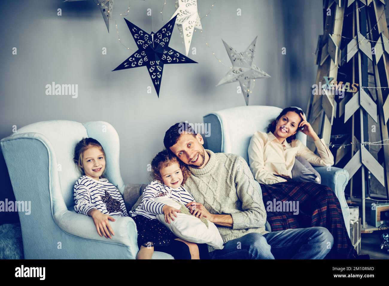 Modern family sitting in hi-res stock photography and images - Alamy