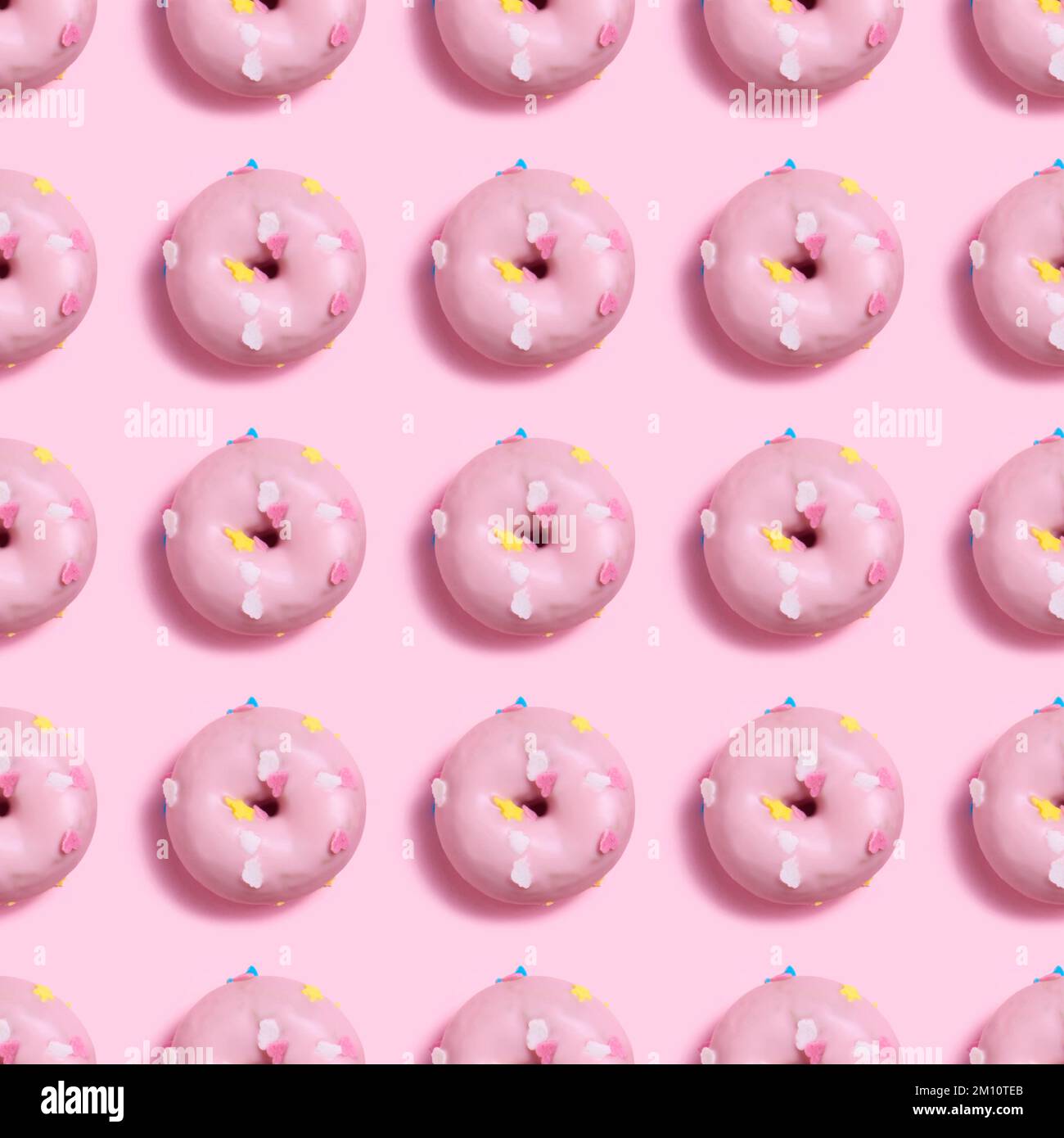 A seamless Pattern of pink donuts on a light pink background Stock ...