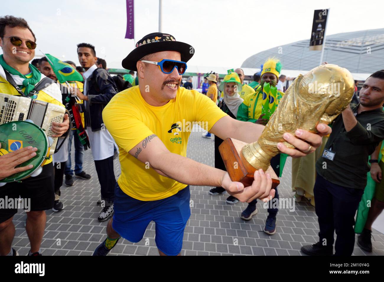 A Brazil fan with a replica World Cup trophy ahead of the FIFA World Cup Quarter-Final match at the Education City Stadium in Al Rayyan, Qatar