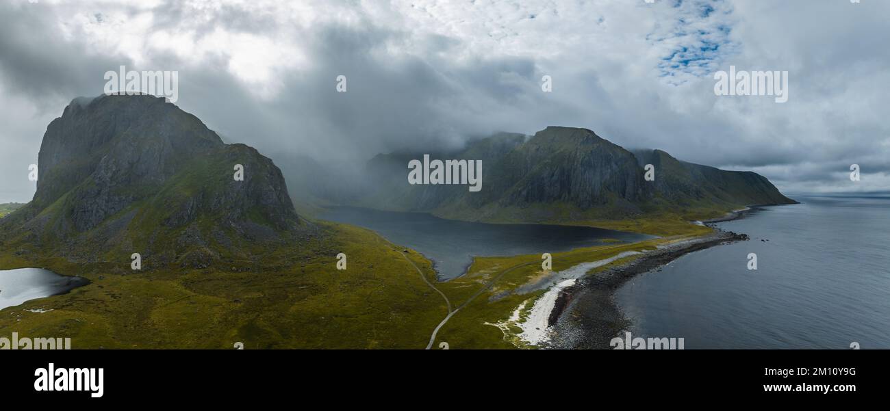 An aerial view of the rocky hills at the shore in Lofoten on a foggy ...