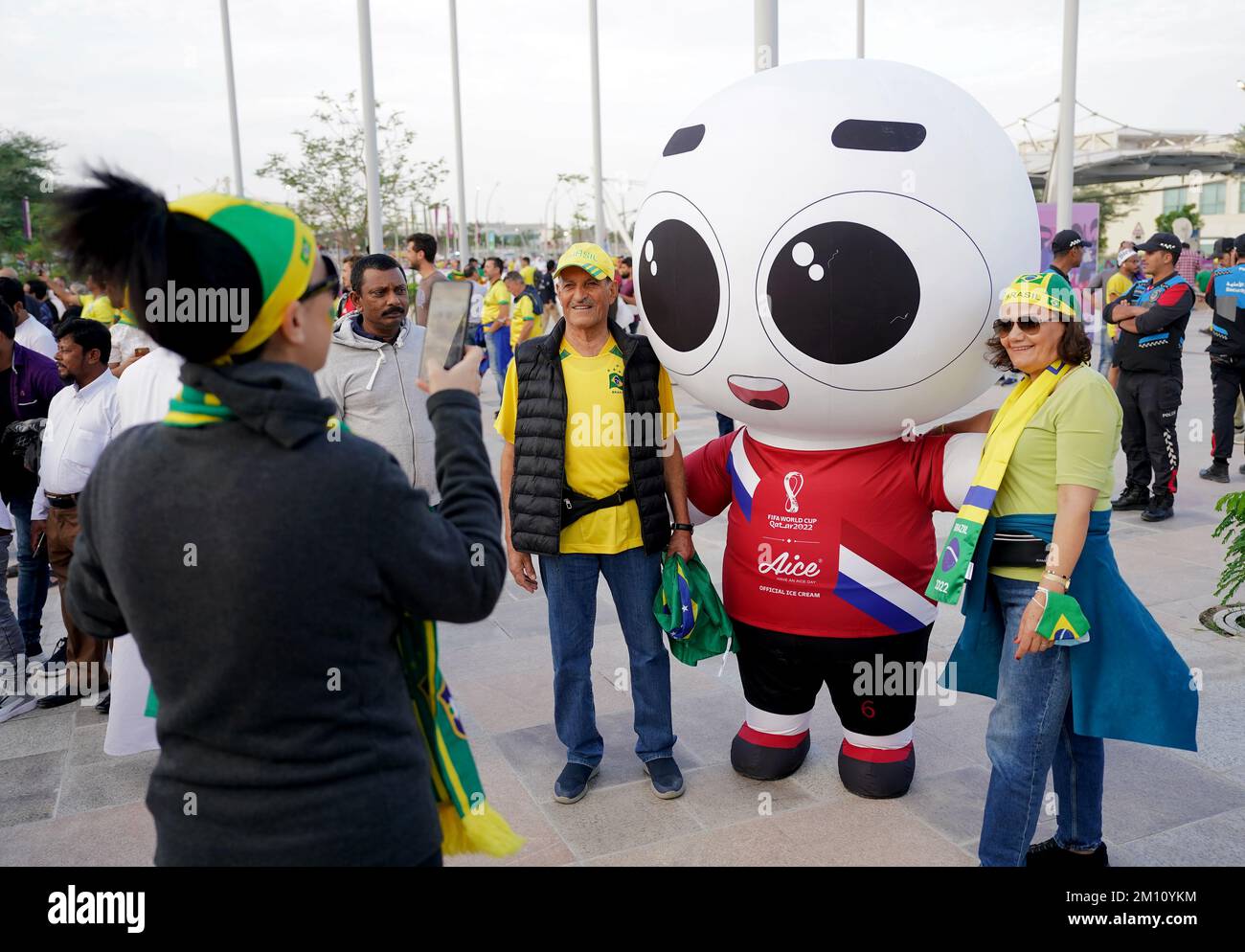 Brazil fans pose with a mascot ahead of the FIFA World Cup Quarter-Final match at the Education City Stadium in Al Rayyan, Qatar. Picture date: Friday December 9, 2022. Stock Photo