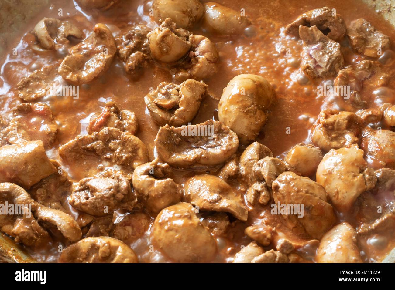 Cooking devilled kidneys, lambs kidneys in a spicy sauce . A Victorian breakfast dish Stock Photo