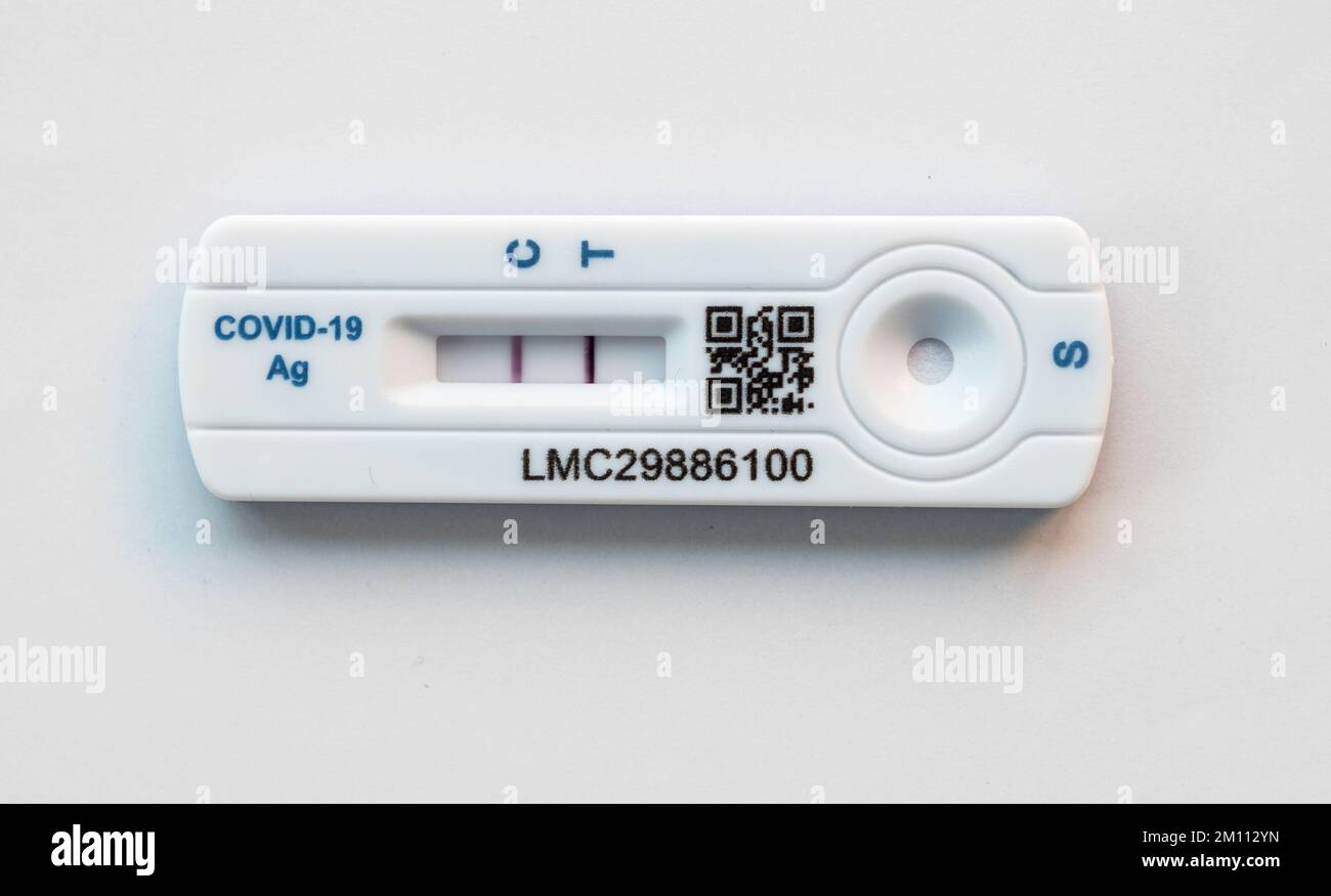 A COVID 19 test cassette showing a strong positive result Stock Photo