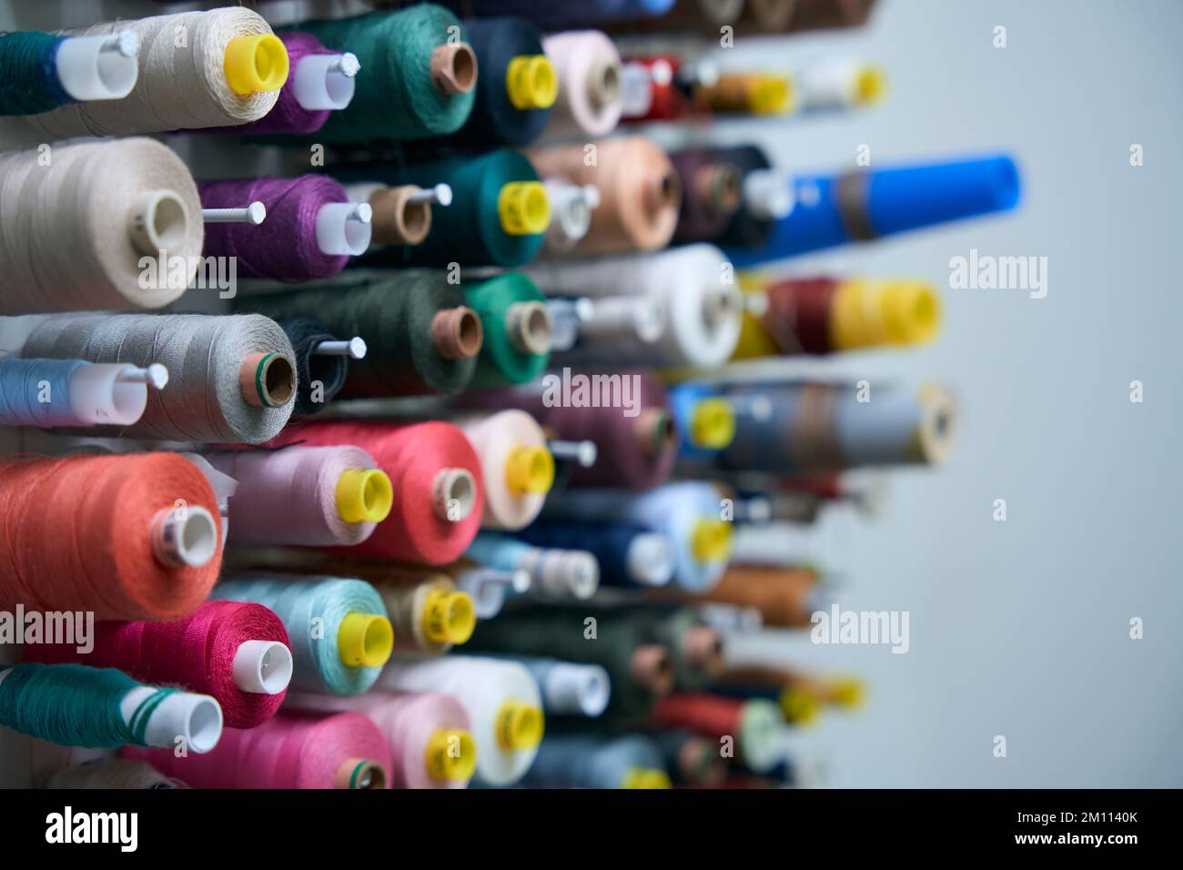Collection of multi-colored spools of thread on special holders Stock ...