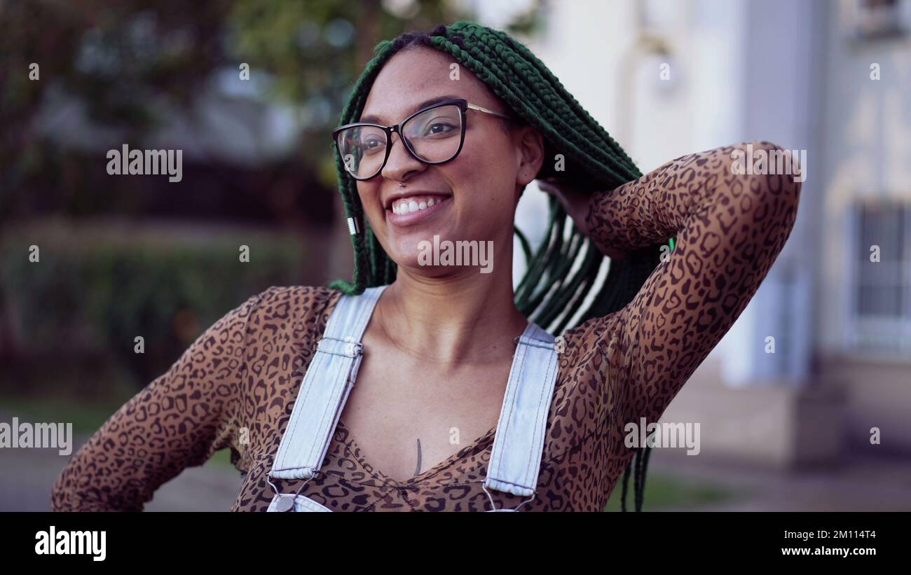 Portrait of a smiling Brazilian young black woman with braided hair ...