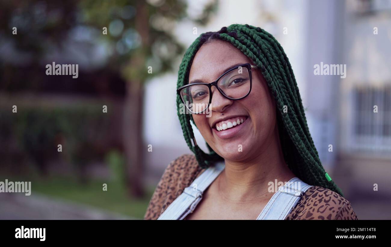Portrait of a smiling Brazilian young black woman with braided hair ...